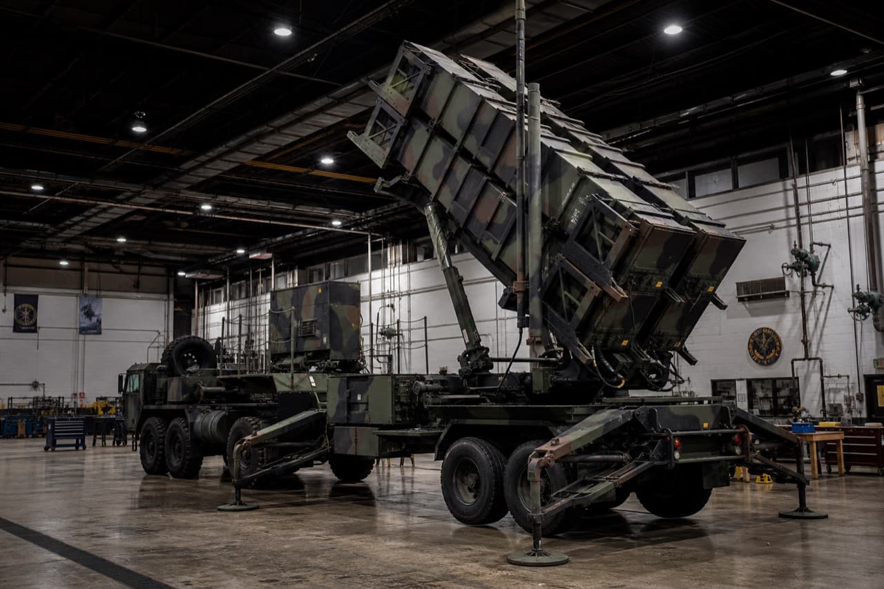 Patriot missile launcher inside a military engineering depot with dramatic lighting